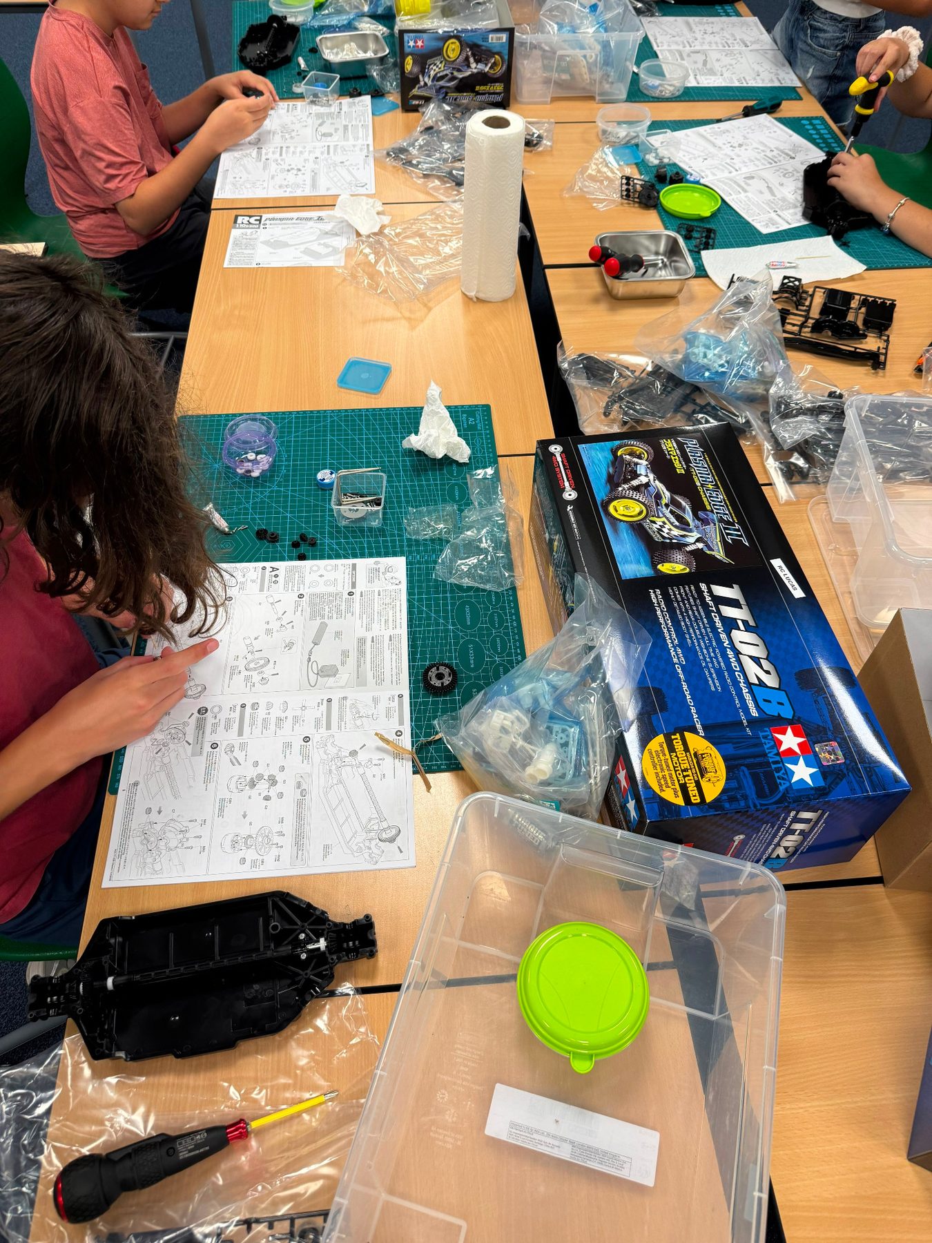 Participants following Tamiya build instructions at RC Garage Summer Camp Vienna