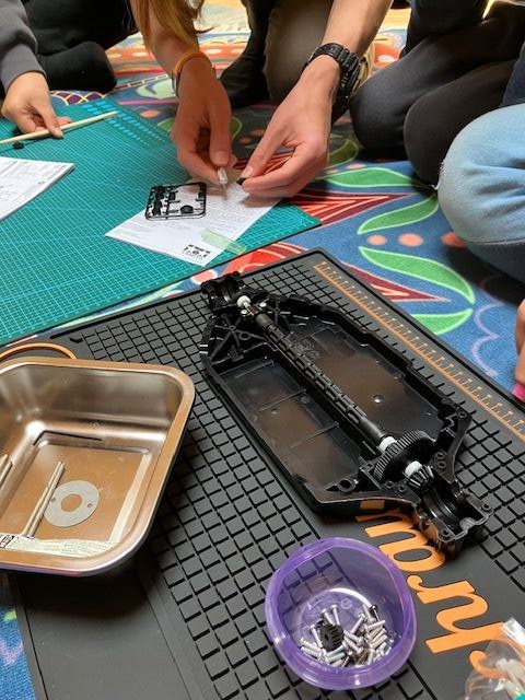 Students building a Tamiya RC car chassis at RC Garage After School in Vienna